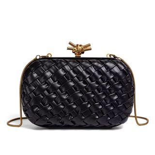 Black woven handbag with gold accents on a white background