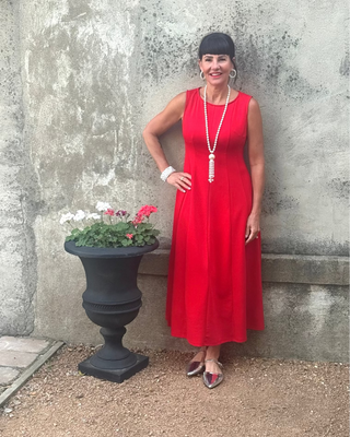 woman in red dress and pearls