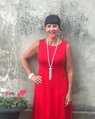 woman in red dress and pearls