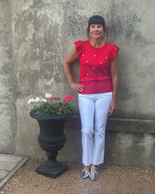 Woman in red summer sweater with flutter sleeves and white emdroidered stars