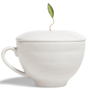White ceramic mug with a lid featuring a green tea leaf on a white background