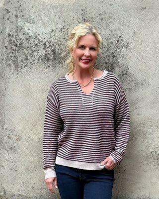 blonde woman in plum and creme stripe sweater