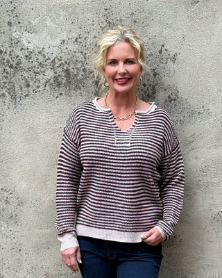 blonde woman in plum and creme stripe sweater