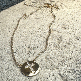Gold necklace with pave cross in round shape