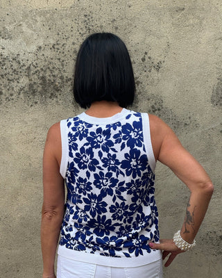 Person wearing a blue floral dress on a concrete floor