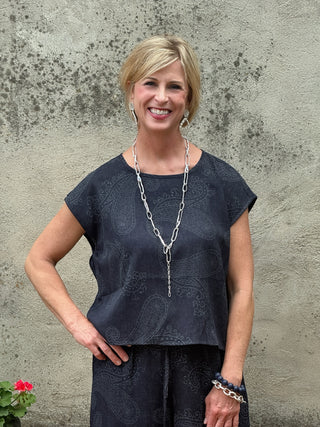 Woman in a paisley print navy top