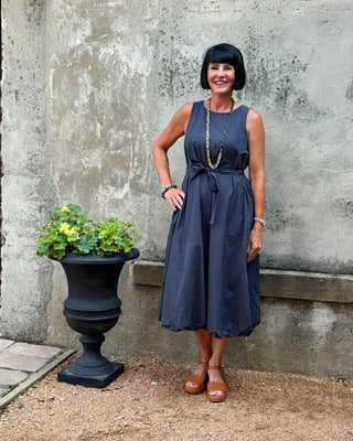 Woman is navy blue bubbe hem dress