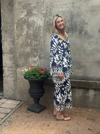 Woman in a trpical print jumpsuit with matching kimono