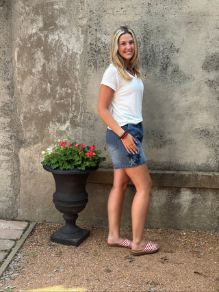 Person lying on a concrete surface with a potted plant nearby