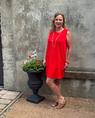 woman in a sleevelss red shift dress