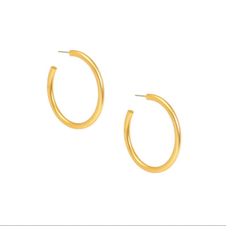 A pair of polished gold-tone open hoop earrings on a solid white background.