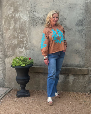 woman in a western top and jeans