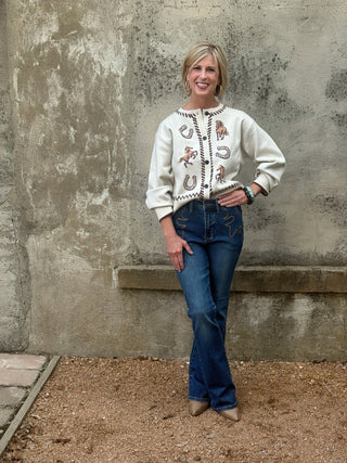 woman in a crene western icons sweater and jeans