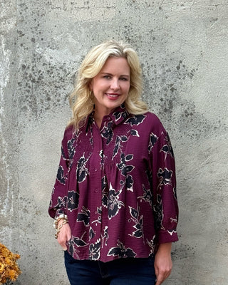 Entro wine floral smocked button-up blouse with collar and three-quarter balloon sleeves, styled with dark wash jeans