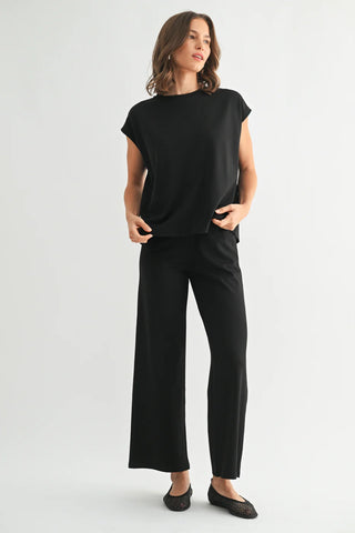Woman wearing a black outfit on a white background