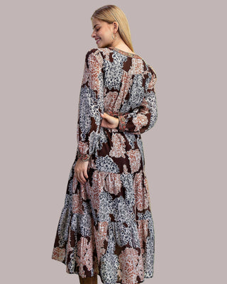 Woman wearing a floral dress on a solid background
