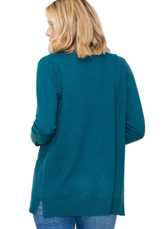 Person wearing a teal cardigan against a white background