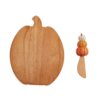 Wooden pumpkin-shaped cutting board with a small pumpkin-shaped knife on a white background