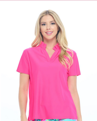 Woman wearing a bright pink polo shirt on a white background